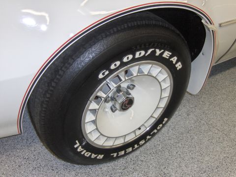 1982 Chevrolet Camaro - Close-up of a white car wheel Goodyear Radial Polysteel tires and distinctive red and blue pinstripes on the fender, consistent with a 1982…