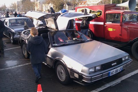 1991 Ford LTD Crown Victoria - DeLorean DMC-12 at an outdoor event, gullwing doors are open.