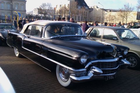 1991 Ford LTD Crown Victoria - Classic black Cadillac convertible from the mid-1950s, seen at an outdoor event.