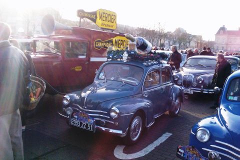 1991 Ford LTD Crown Victoria - A vintage Renault 4CV is parked next to a promotional truck, both adorned with Mercier Champagne branding.