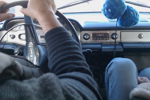 1991 Ford LTD Crown Victoria - The interior of a classic car, a retro dashboard and fuzzy blue dice hanging from the mirror.