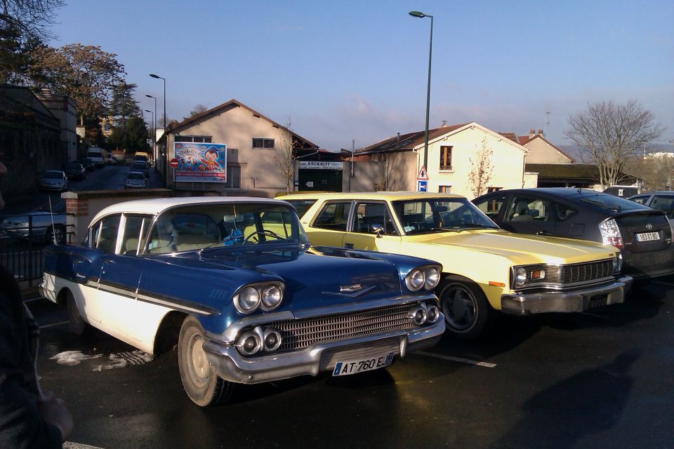 Blue and white 1958 Chevrolet Bel Air parked next to a yellow car