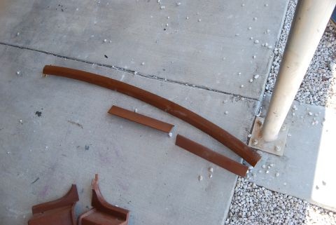 1982 Ford Bronco - Several metal trim pieces are laid out on a concrete surface.