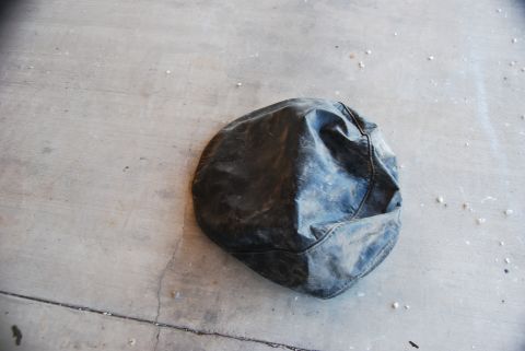 1982 Ford Bronco - A black tire cover rests on a concrete surface, with a Supermotors.net watermark visible.