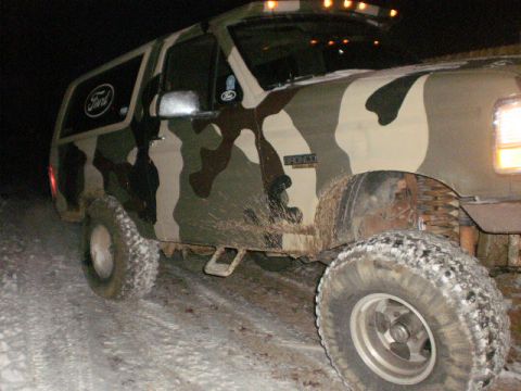 1995 Ford Bronco - This 1995 Ford Bronco is covered in camouflage and driving through snow.