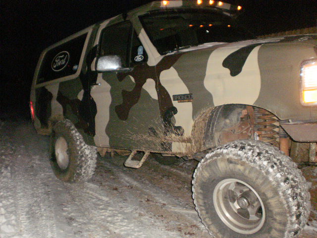 Camouflaged 1995 Ford Bronco in snow, 3/4 front view