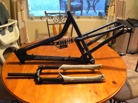 1978 Ford Bronco - A Santa Cruz bicycle frame and Marzocchi Bomber fork are displayed on a wooden table.