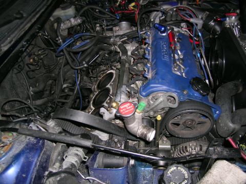 1995 Ford Probe - Close-up view of a complex engine bay with various components and wiring.