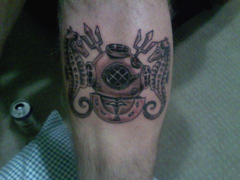 1989 Ford Bronco - This tattoo features a classic diving helmet flanked by two seahorses, with tridents above.