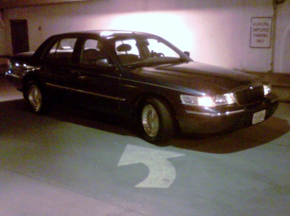 Dark 1998 Mercury Grand Marquis, 3/4 front view