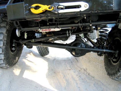 1985 Ford Bronco - Undercarriage view of an off-road vehicle, showing suspension components and a winch.