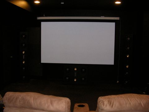 1987 Ford Bronco - Home theater setup with a large projection screen and surround sound speakers.