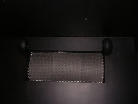 1987 Ford Bronco - A textured mat is visible in the interior of a vehicle, secured by black handles.