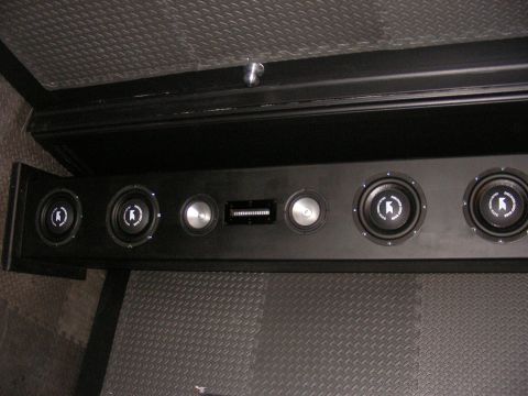 1987 Ford Bronco - A custom speaker box with several speakers and a vent is installed in the vehicle's interior.