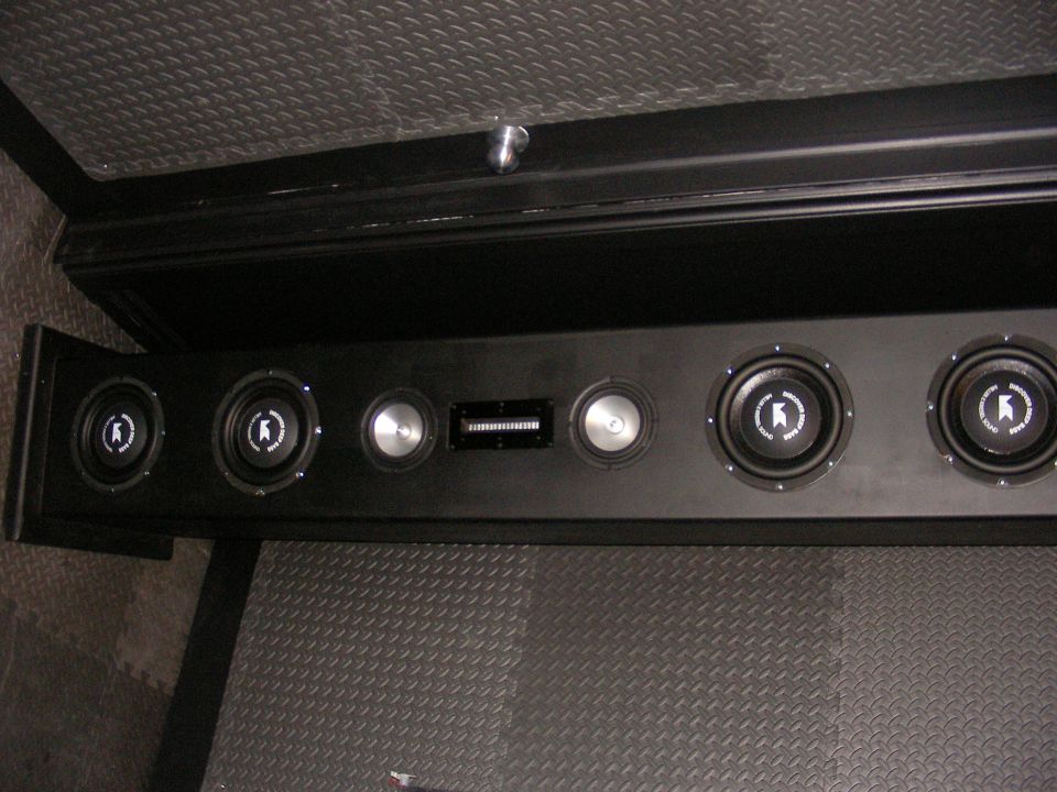 Custom speaker box with multiple speakers and a rectangular vent, mounted in a vehicle