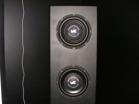 1987 Ford Bronco - Dual subwoofers are mounted in a black cabinet, with text visible on the speaker cones.
