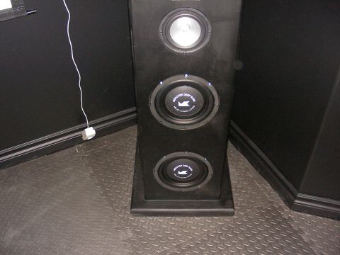 1987 Ford Bronco - Speaker cabinet with three drivers, two labeled 'Discover Deep Bass', and a white power cord.