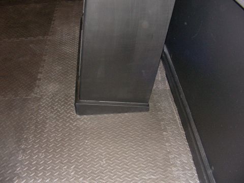 1987 Ford Bronco - A black cabinet sits on a textured floor.