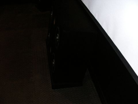 1987 Ford Bronco - Close-up of a black interior speaker grille, showing the mounting screws and textured surface.