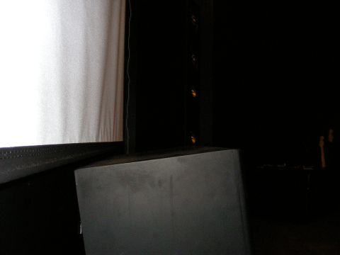 1987 Ford Bronco - A large speaker sits in front of a projection screen in a dimly lit room.