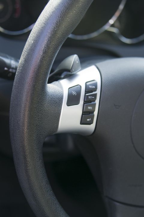 2006 Cadillac STS - Close-up of a steering wheel interior, showing paddle shifters and cruise control buttons.