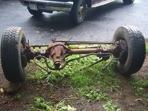 1992 Ford F-150 - Rusty front axle assembly with wheels and steering components removed from a vehicle.