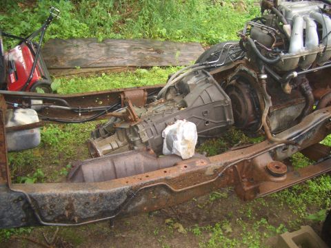 1992 Ford F-150 - The engine and transmission have been removed from this truck chassis, revealing a heavily rusted frame and components.