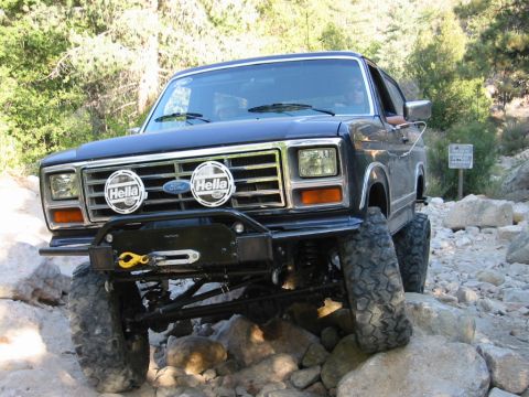 1985 Ford Bronco - This modified Ford Bronco navigates a rocky trail with its front end angled towards the viewer.