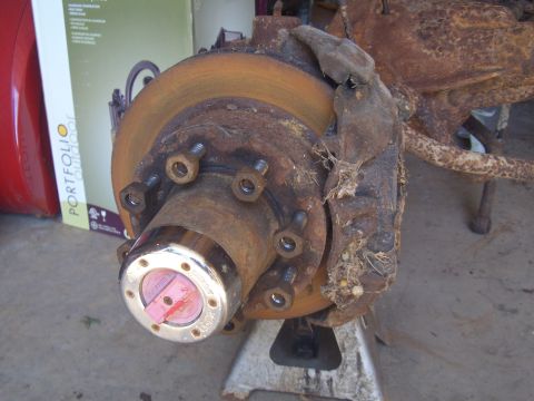 1992 Ford F-150 - This heavily rusted front wheel hub and brake assembly is a part of a truck build, but its specific year and model are not identifiable fro…