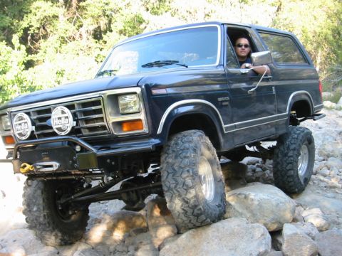 1985 Ford Bronco - This lifted 1985 Ford Bronco tackles a challenging rocky trail, its off-road capabilities.