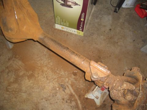 1992 Ford F-150 - A heavily rusted rear axle assembly is shown resting on a concrete floor.