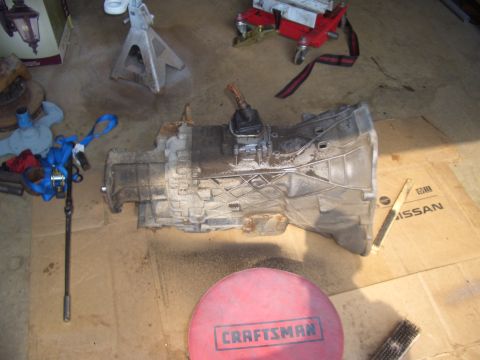 1992 Ford F-150 - A transmission sits on a cardboard box with the Nissan logo visible.