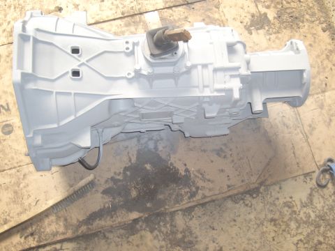 1992 Ford F-150 - A transmission part, painted gray, is shown resting on a wooden surface.
