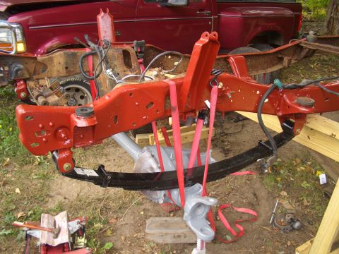 1992 Ford F-150 - The red frame and suspension components of a 1992 Ford F-150 truck are visible in this image.