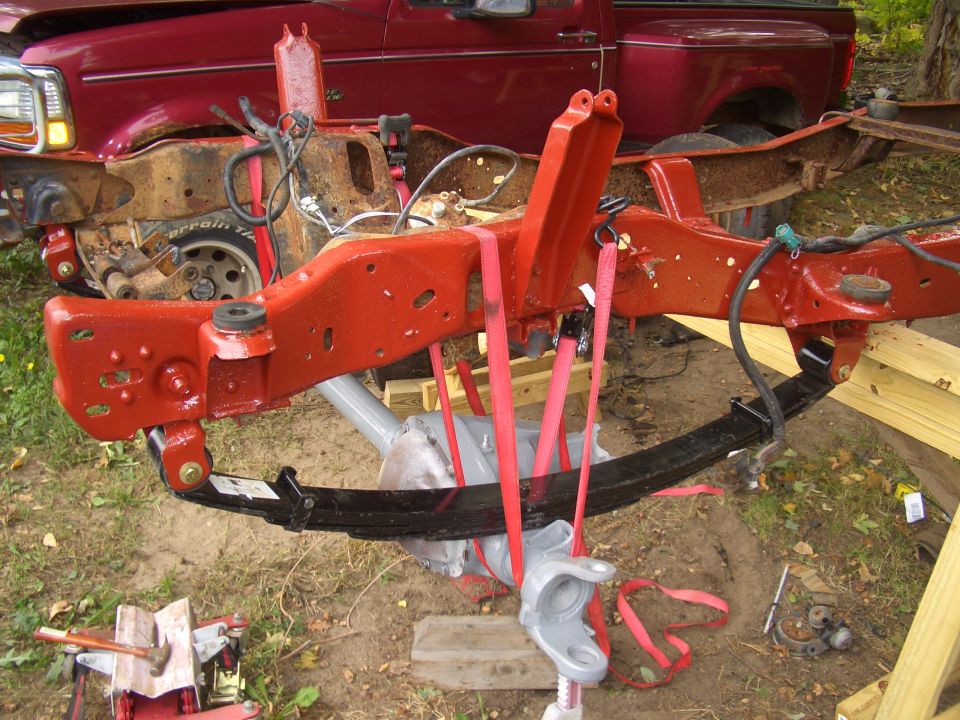 Red 1992 Ford F-150 truck frame with red suspension components