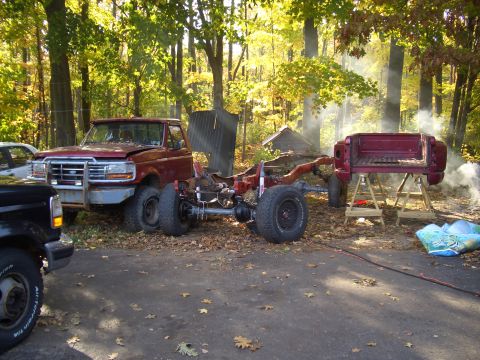 1992 Ford F-150 - Ford F-150 chassis undergoing work outdoors with a separate cab and bed nearby.