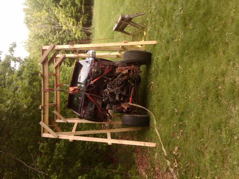 1992 Ford F-150 - A 1992 Ford F-150 is suspended by an engine hoist, revealing its engine compartment.