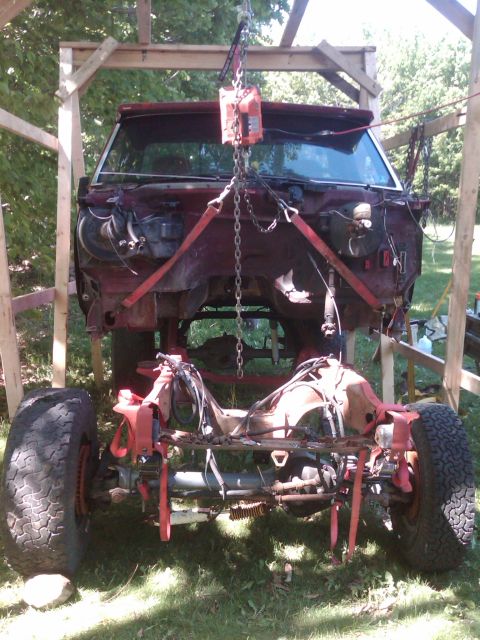 1992 Ford F-150 - 1992 Ford F-150 chassis is hoisted for work, showing the frame and suspension components.