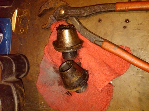 1992 Ford F-150 - Greasy automotive parts and pliers on a rag, likely during a repair or repair.