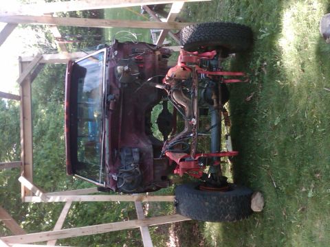 1992 Ford F-150 - This truck chassis is being worked on outdoors, with the body removed and components exposed.
