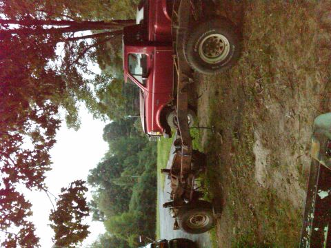 1992 Ford F-150 - Side view of a red 1992 Ford F-150 pickup truck chassis and cab.