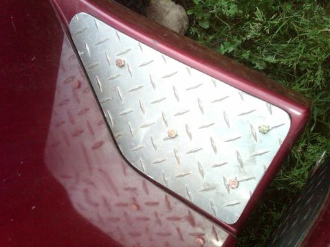 1992 Ford F-150 - Close-up of a diamond plate step attached to the fender of a red truck.