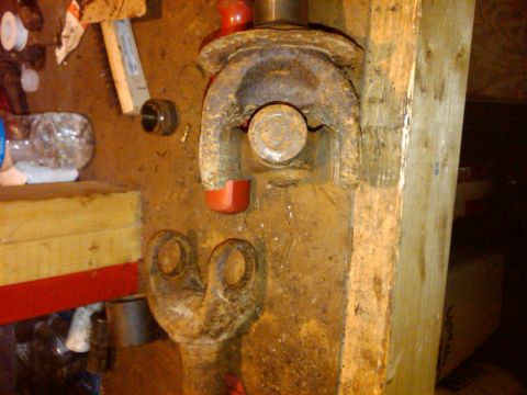 1992 Ford F-150 - Rusty driveshaft universal joint part shown in a workshop setting.