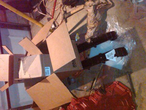 1992 Ford F-150 - Various automotive parts and boxes are scattered across a cluttered floor.