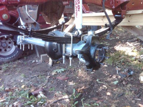1992 Ford F-150 - Close-up of a truck's rear axle assembly, showing leaf springs and a Rough Country shock absorber.