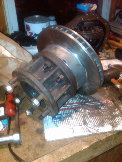 1992 Ford F-150 - A close-up view of a truck's brake rotor and hub assembly, likely for repair or replacement.