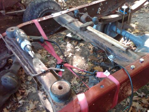 1992 Ford F-150 - Close-up of a vehicle frame, possibly undergoing repairs or modifications, with tools present.