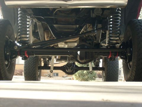 1986 Ford Bronco - Undercarriage view of a 1986 Ford Bronco, highlighting its 4x4 suspension and rear differential.