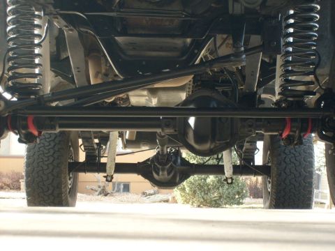 1986 Ford Bronco - This photo shows the undercarriage of a 4x4 vehicle, focusing on its suspension and drivetrain components.