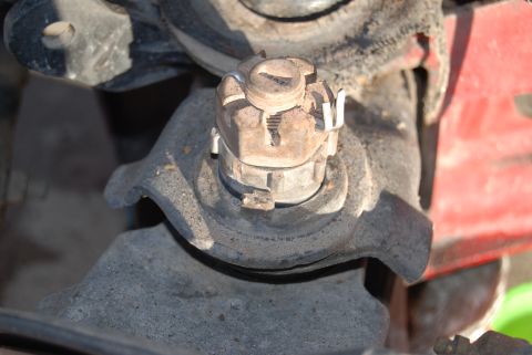 1982 Ford Bronco - This is a close-up view of a vehicle's wheel hub assembly, focusing on the nut and cotter pin.